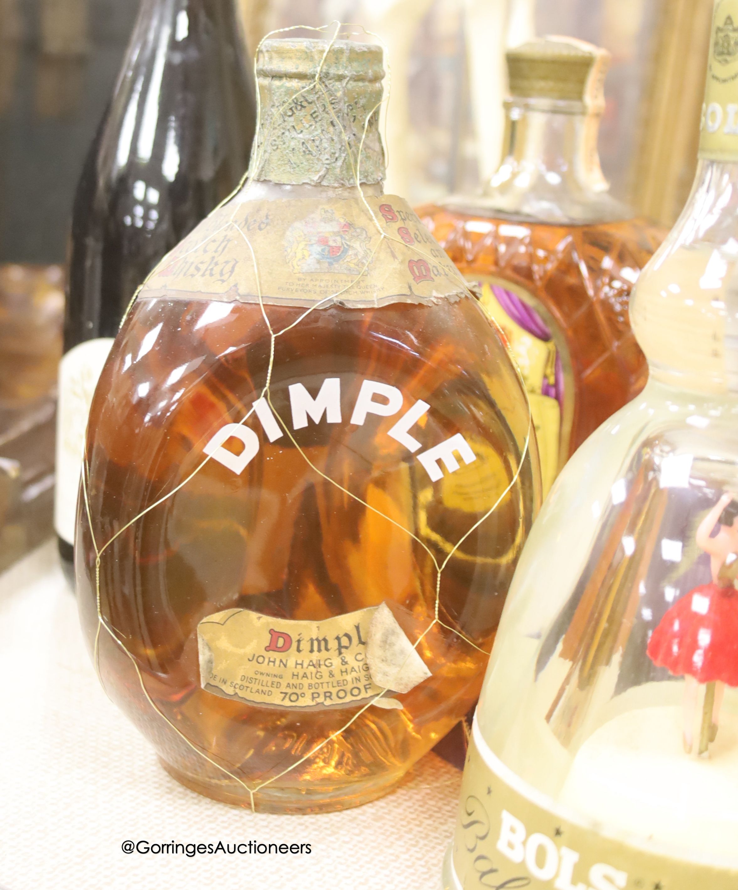 One bottle of Haig Dimple Scotch Whisky, one Crown Royal Canadian Whisky, one Bols Ballerina and one Royal Over-seas (egue vin de pays wine)